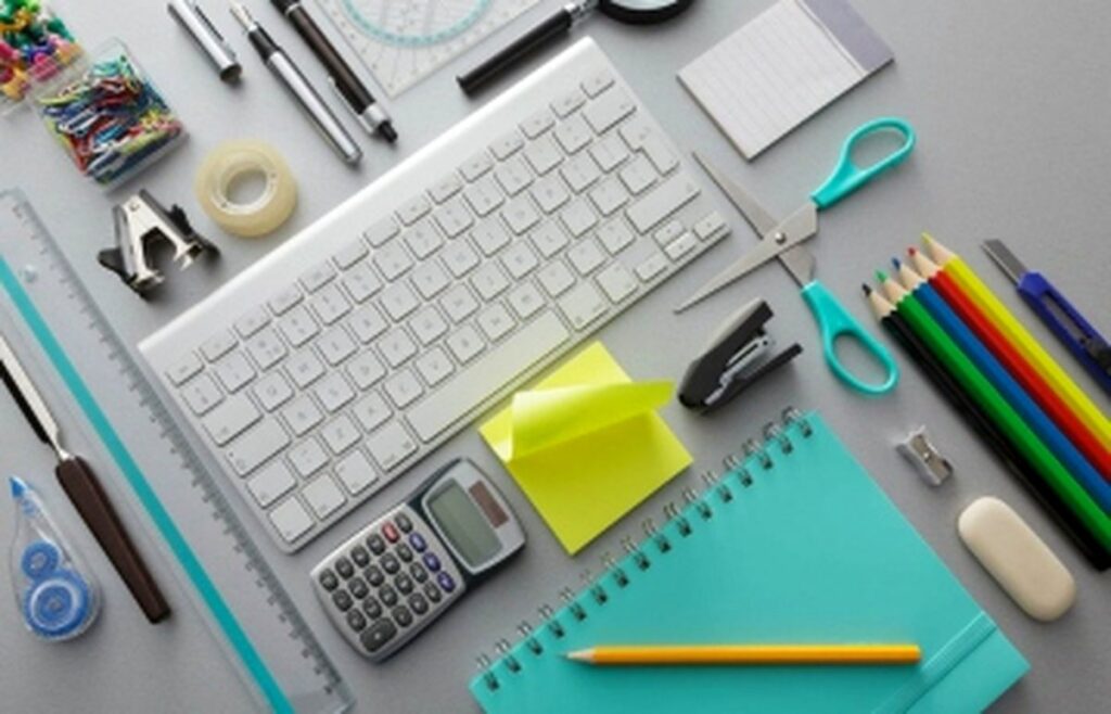 Office stationery, notebooks and computer accessories on a desk